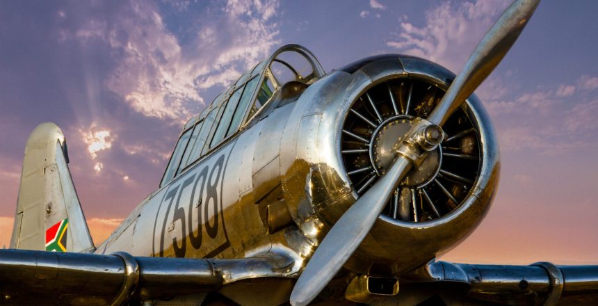 large-silver-plane-at-sunset-with-large-propellers